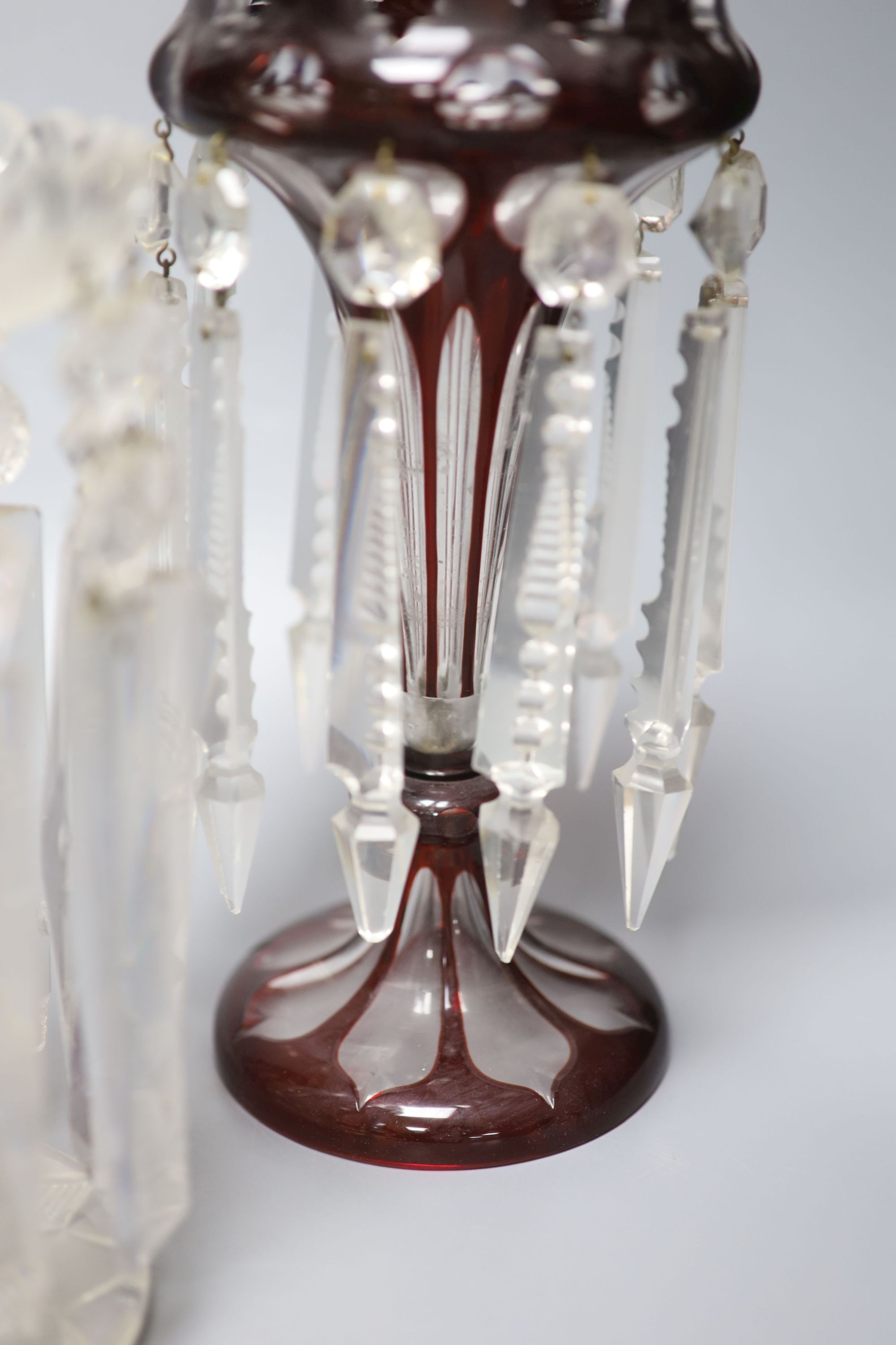 A pair of Victorian ruby overlaid table lustres and a pair of late Victorian clear glass table lustres, height 24cm